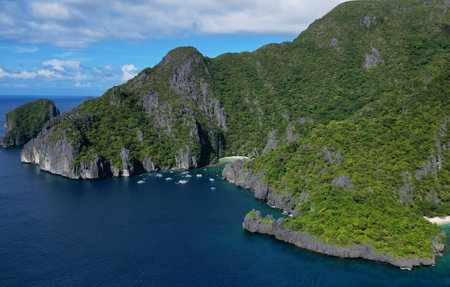 Aerial view of tropical Philippines island. White sand beach, rocks cliffs mountains with blue bay and coral reefの写真素材