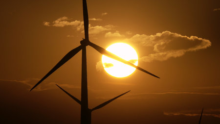 Windmills or wind turbine in sunrise lightの写真素材