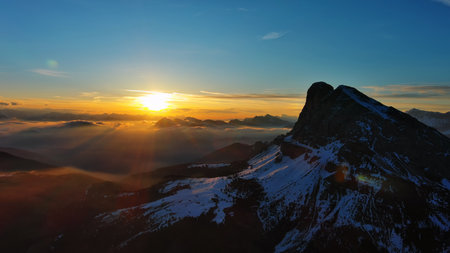Aerial view of amazing rocky mountains in snow and sunrise sun, Dolomites, Italyの写真素材