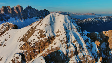 Aerial view of amazing rocky mountains in snow at sunrise, Dolomites, Italyの写真素材