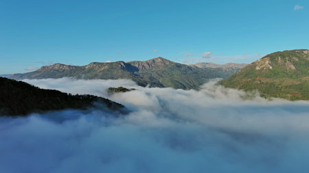 Aerial view of clouds and mountains at sunrise