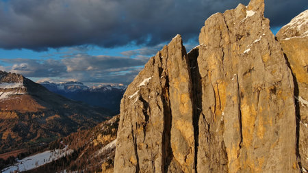 Rocky snow mountains at sunset aerialの写真素材