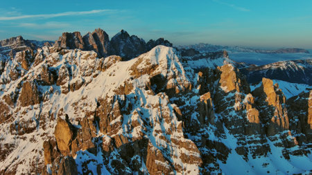 Aerial view of amazing rocky mountains in snow at sunrise, Dolomites, Italyの写真素材