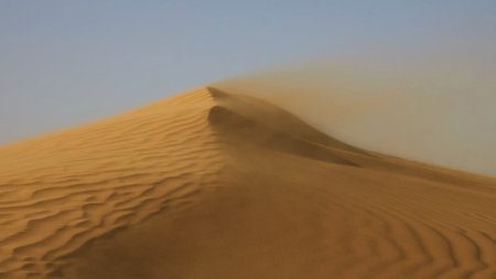 Sand blowing over large sand dunes in wind, Sahara desertの写真素材