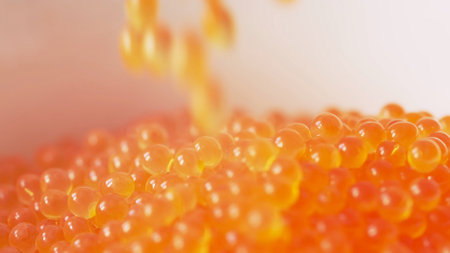 Falling red caviar closeup macro view. Background. Delicacy product of the highest quality
