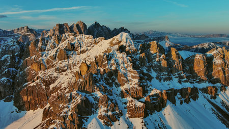 Aerial view of amazing rocky mountains in snow at sunrise, Dolomites, Italyの写真素材