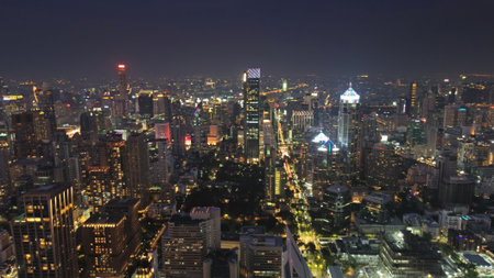 Aerial view on illuminated skyscrapers and Lumpini park in Bangkok city at night, Thailandの写真素材