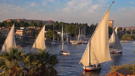 Beautiful landscape with felucca boats on Nile river in Aswan at sunset, Egypt, timelapse