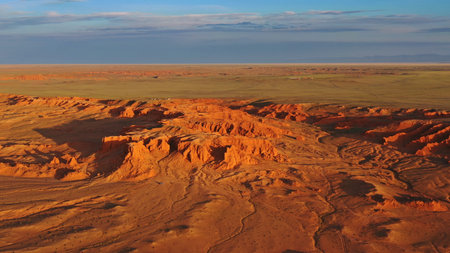 Aerial view of the Bayanzag flaming cliffs at sunset in Mongolia, found in the Gobi Desertの写真素材
