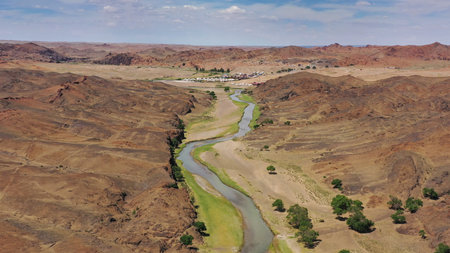 Aerial view of Ongiin Gol river and yurt camping between mountains in Mongolia
