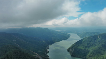 Aerial view on Danube river and mountains under clouds