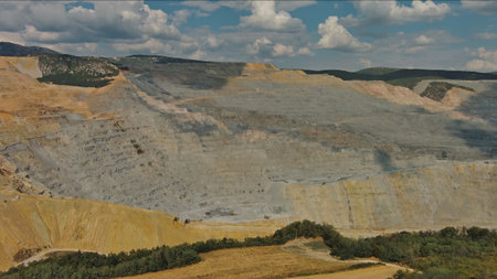 Aerial of open mine and heavy mining equipment
