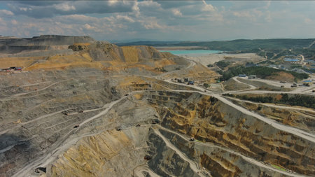 Aerial of open mine and heavy mining equipment