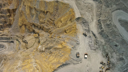 Aerial of open mine and heavy mining equipment