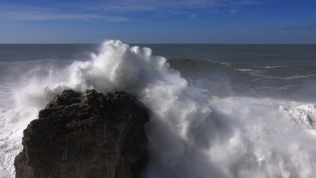 High waves breaking on the rocks of the coastline