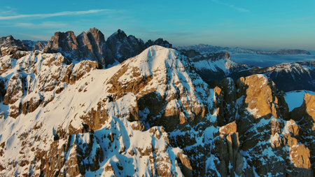 Aerial view of amazing rocky mountains in snow at sunrise, Dolomites, Italyの写真素材