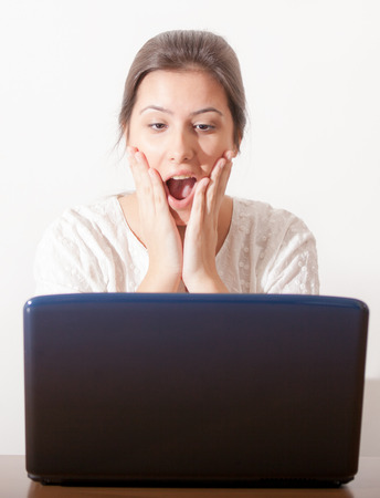 Surprise young girl and laptopの写真素材