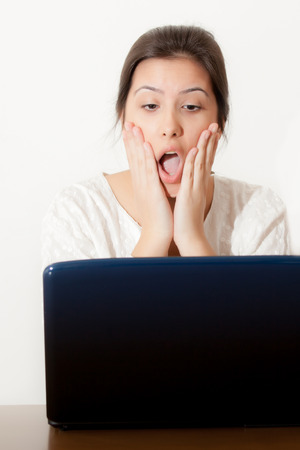 Surprise young girl and laptopの写真素材