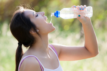 Young girl drinking waterの写真素材