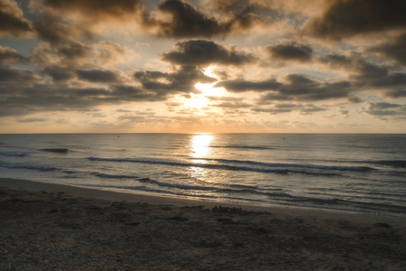 Sunrise on the beach and cloudsの写真素材