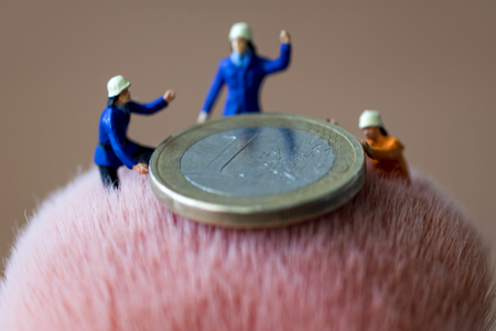 Mini figures and euro coinの写真素材