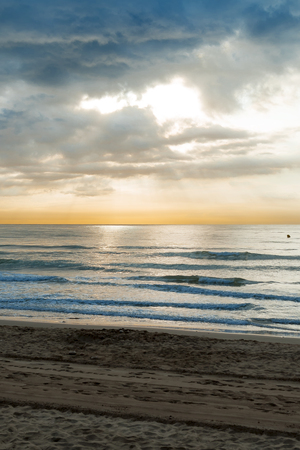 Sunrise on the beach and cloudsの写真素材