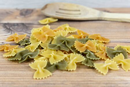 Tricolor farfalle raw pasta closeup