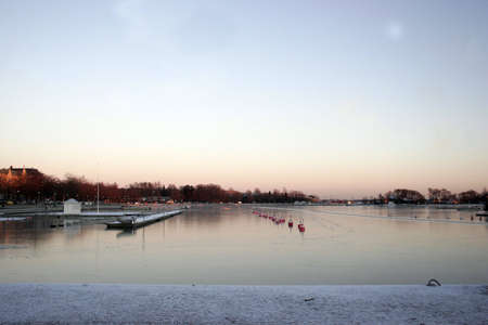 Buoys and pier in the frosen seaの写真素材