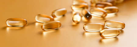 Many capsules Omega 3 on yellow background. Close up, high resolution product. Health care concept.の写真素材