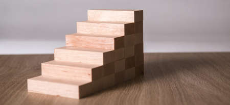 Wooden blocks in shape of a staircase as step for success in business.の写真素材