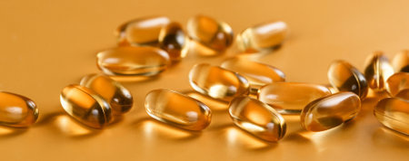 Many capsules Omega 3 on yellow background. Close up, high resolution product. Health care concept.の写真素材