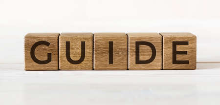 Guide word made from wooden cubes on light background.の写真素材