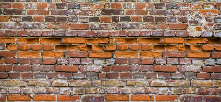 Background of red brick wall texture. Ruined castle.の写真素材