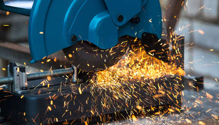 Close up of cutting steel pipe with an electric tool. Many sparks.の写真素材