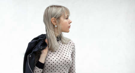 Outdoors lifestyle portrait of happy stunning blonde girl. Walking to the city street.の写真素材