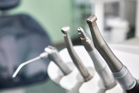 Dental drill close up and other dentist tools on a dentist chair in Dentist Clinic.の写真素材