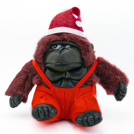 Toy red monkey gorilla in Christmas hat.の写真素材