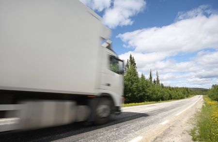 truck driving on country-road/motion blurの写真素材