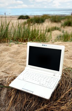 White small Laptop on the beachの写真素材