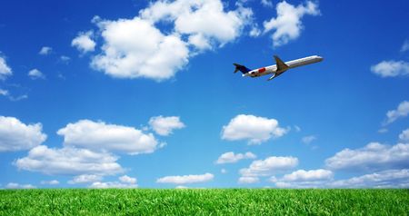 Airplane over grassy fieldの写真素材