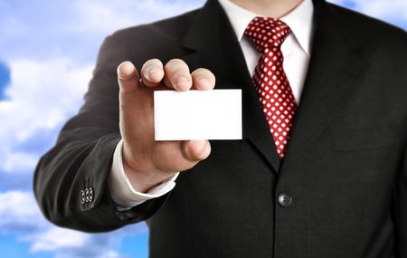 Businessman showing his business card, focus on fingers and card. の写真素材