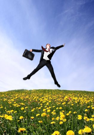 Jumping business man on Green Fieldの写真素材
