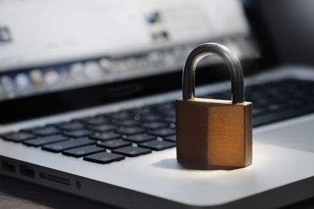 Lock on laptop keyboard with shallow depth of field