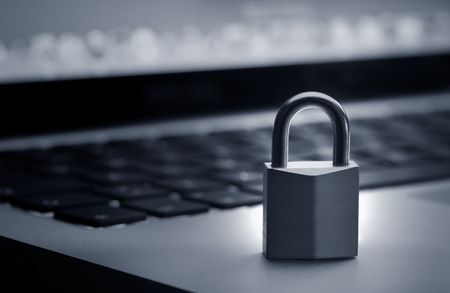 Lock on laptop keyboard with shallow depth of field