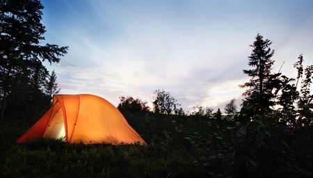 A tent lit up at dusk の写真素材