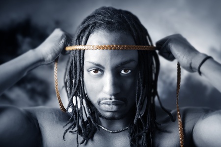 Shot of a young man on a cloud background looking in the cameraの写真素材