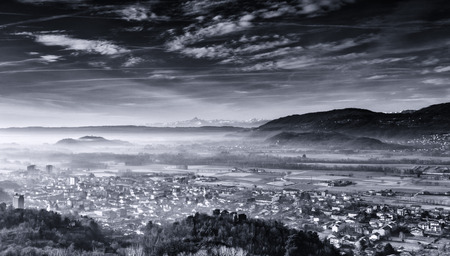 the town of Montalto Dora dipped in morning mists with the Alps and the background monvisoの写真素材