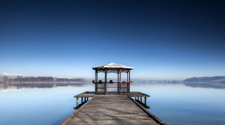 Lake candia in a quiet moment with gazebo and dockの写真素材
