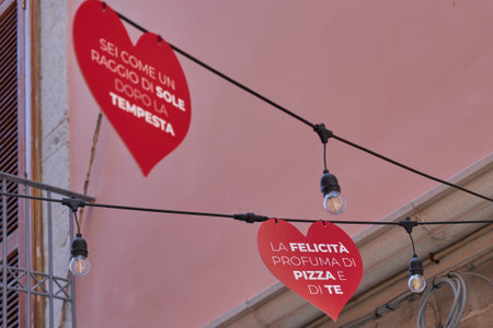 Colorful Italian alley with red heart signs and romantic phrases about love and pizza, symbol of...