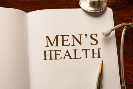 Page with Men's Health on the table with stethoscope, medical conceptの写真素材